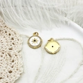 Detail of 18K gold plated compass star charms with white enamel and blue zircon stones - Enamel Compass Starburst / Enamel Compass