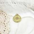 Macro detail of 18K gold plated sunburst compass pendant with micro zircon inlay - Sunburst Large Round Plate / Large Round Disc