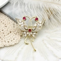 Elegant gold butterfly brooch with red gemstones and sparkling white micro-pave crystals - Butterfly Design