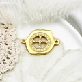 Macro shot of gold St. Benedict medal pendant with holy cross engraving on lace background - Button Cross Style