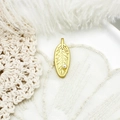 Golden leaf pendant with fine texture and white pearl detail on woven background - Leaf Artificial Pearl Style