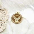 Macro shot of gold-plated dove pendant with zircon pavé and hollow pattern - Eagle Round Plate