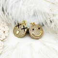 Detail of 18K gold-plated smiley face charms with micro-pave crystals on lace - Black X Eyes Expression Face