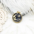 Detail view of 18K gold plated celestial pendant with moon, star and black enamel - Grey Star Moon Medallion (4790032025943)