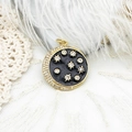 Detailed close-up of 18K gold plated celestial charm with black enamel and zircons - Large Grey Star Moon Medallion (4790032025941)