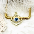 Detail view of a 18K gold plated evil eye pendant with blue iris and mystical star accents - Planet Eye