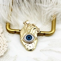 Detailed macro view of 18K gold plated anatomical heart pendant with blue evil eye stone - Anatomical Heart Eye