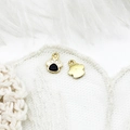 Macro view of gold-plated cat paw pendants with black and white enamel for DIY jewelry - Cat Paw