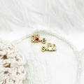 Detailed macro view of 18K gold plated Love charms with red heart on white lace fabric - Alphabet