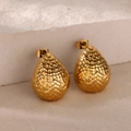 Macro view of gold teardrop stud earrings with a unique hammered metal texture finish - Hammered Teardrop Style (E5444)
