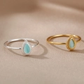 Detail view of oval semi-precious stone rings in gold and silver stainless steel finishes - Gold / Light Cyan Artificial Cat Eye Stone