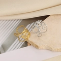 Detailed close-up of textured gold and silver open rings with hollow geometric patterns - Hollow Eye Shape (JZ7654) / Gold