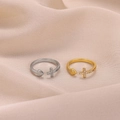 Close-up of gold and silver open rings with pavé cross and heart on pink satin cloth - Heart Cross Style (JZ8130) / Gold