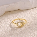 Macro shot of 18K gold plated double band ring with sparkling white zircon stones - Gold