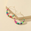 Bohemian gold hoop earrings featuring colorful clay discs and gold beads on stone - Colorful