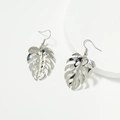 Silver monstera leaf drop earrings with hollow metal texture on a white display pedestal - Silver (E0454 Silver)