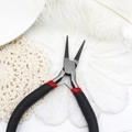 Macro shot of steel round nose jewelry pliers on lace and feather backdrop - Round Nose Pliers
