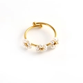 Minimalist golden open ring featuring three white floral stone motifs on a white background - White