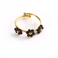 Adjustable gold flower ring with three black faceted stone blossoms and polished finish - Black