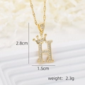 Macro view of gold crown letter H pendant with zircon stones including size specifications - Gold H