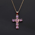 Detailed view of a gold-plated cross pendant featuring oval purple cubic zirconia stones - Pink
