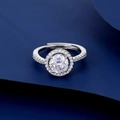 Macro detail of silver ring featuring halo-set round cubic zirconia and pavé diamond band - Round Halo Style (D)