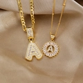 Close-up of golden letter A necklaces with iced out zircon pavé on silk background - Iced and Flower Necklace Set (Letter A)