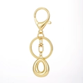 Detailed macro view of an 18K gold-plated alphabet keychain with a polished lobster clasp - Gold - Letter O