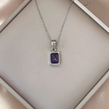 Detail of luxury square purple zircon pendant necklace on champagne silk in a gift box - Purple