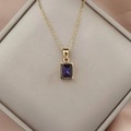 Macro detail of 18K gold stainless steel necklace with square purple zircon pendant - Fuschia