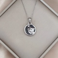 Macro view of Leo zodiac coin pendant with lion head relief on silk jewelry box - Silver-Leo