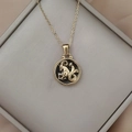 Detail of gold Capricorn necklace with black enamel pendant and star in a gift box - Gold-Capricorn