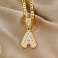 Iced out gold letter A pendant necklace with CZ crystals on a Figaro chain strap - Baguette Letter A And Figaro Chain