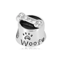 Macro shot of a 316L stainless steel dog bowl charm with zircon bone and Woof engraving - White Dog Bowl Style