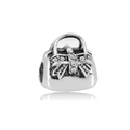 Detailed macro view of a silver handbag charm with sparkling crystal bow for DIY bracelets - White Handbag Style