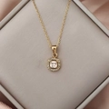 Detail of a gold cushion-cut zircon pendant with a halo setting on a delicate chain - Pink