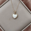 18K gold plated necklace with a white heart pendant on a pink silk background - Ivory