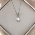 Elegant stainless steel necklace with a sparkling zircon starfish pendant on silk fabric - White