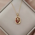 Vintage necklace featuring a red oval tulip pendant with lava texture and gold cross chain - Tulip Irregular Round Plate Style / Ivory