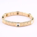Macro detail of gold-tone elastic bracelet with square clear crystals and metal ribs - Clear White