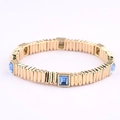 Detailed close-up of light blue square crystals on a gold-plated elastic bracelet band - Light Blue