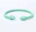 Detailed top view of mint green matte twisted cable open bangle with spherical ends - Bright Green