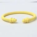 Macro detail of the matte yellow twisted cable texture on this minimalist open cuff bangle - Light Yellow