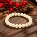 Detailed view of milky white glass bead bracelet on dark wood base with berries decoration - Milky White Style (GBC025-15)