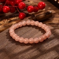 Detailed view of translucent pink crystal beads on a vintage dark wood background - Pink Style (GBC025-7)