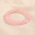 Pulsera de cuentas redondas rosa translúcido 10mm sobre fondo de tela texturizada - Rosa (GBC018-4)