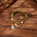 Detail of beaded bracelet with green cat-eye stones, baroque pearls and clover pendant - Green (GBC09-3)