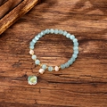 Detail of beaded bracelet with cat eye stones, freshwater pearls and clover charm - Light Blue (GBC09-7)