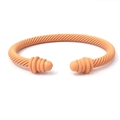 Matte peach pink twisted cable cuff bracelet with textured spiral design and capped ends - Orange