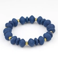 Elastic beaded bracelet featuring dark blue spindle wood beads and gold spacer accents - Dark Blue